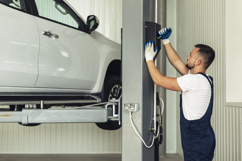 front-view-male-lifting-up-car-inspection